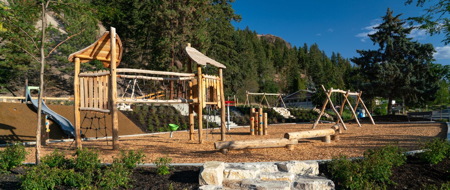 Natural playground with wood and rock elements in a very natural neighbourhood