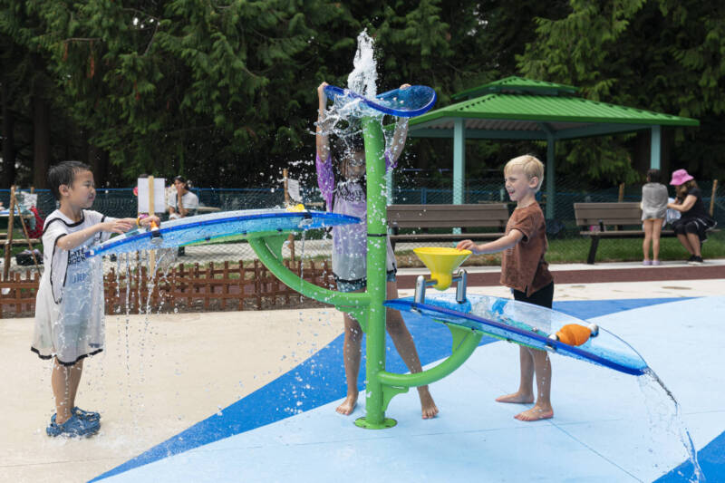 Children playing on a Waterfall 2 from Waterplay at the new Generations Playground Splash Pad in White Rock, BC