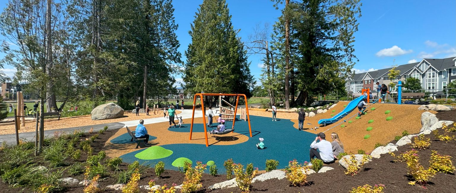 Community playground with kids playing on all features including swings and a slide
