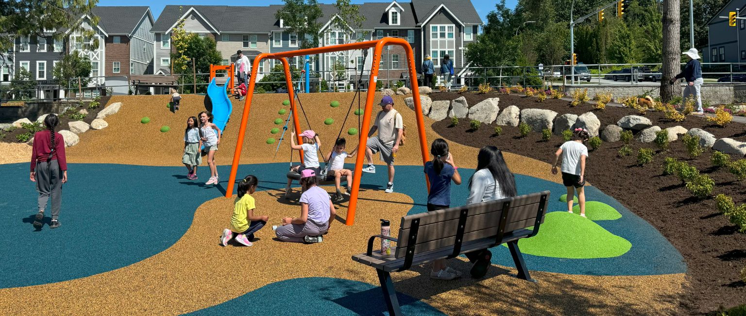 Comfortable bench seating at inclusive playground designed with accessible surfacing