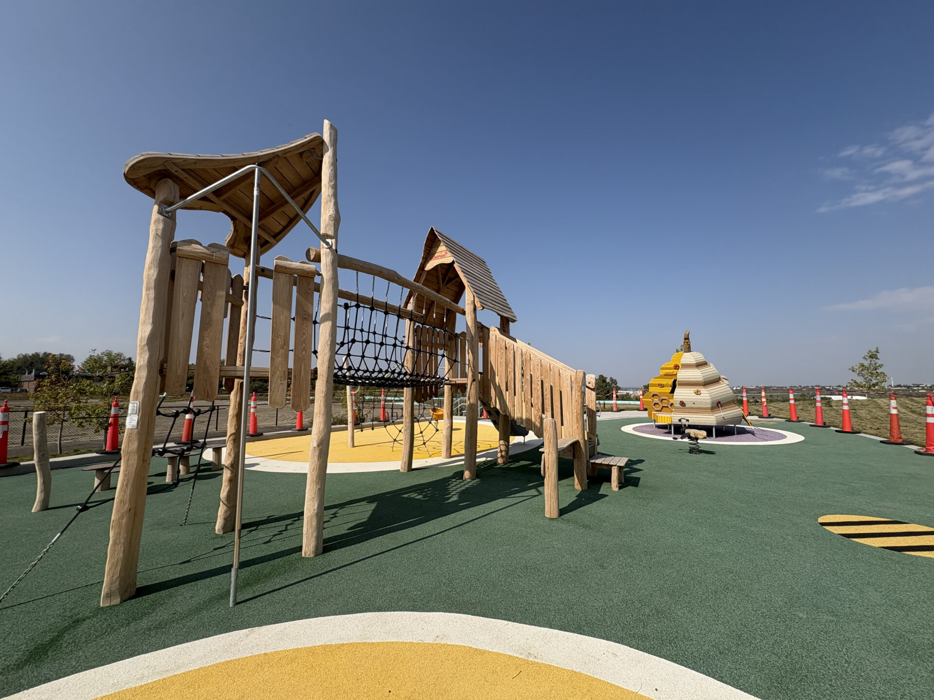 Pollinator themed playground in Midfield Heights, Calgary, featuring KOMPAN structures and equipment.