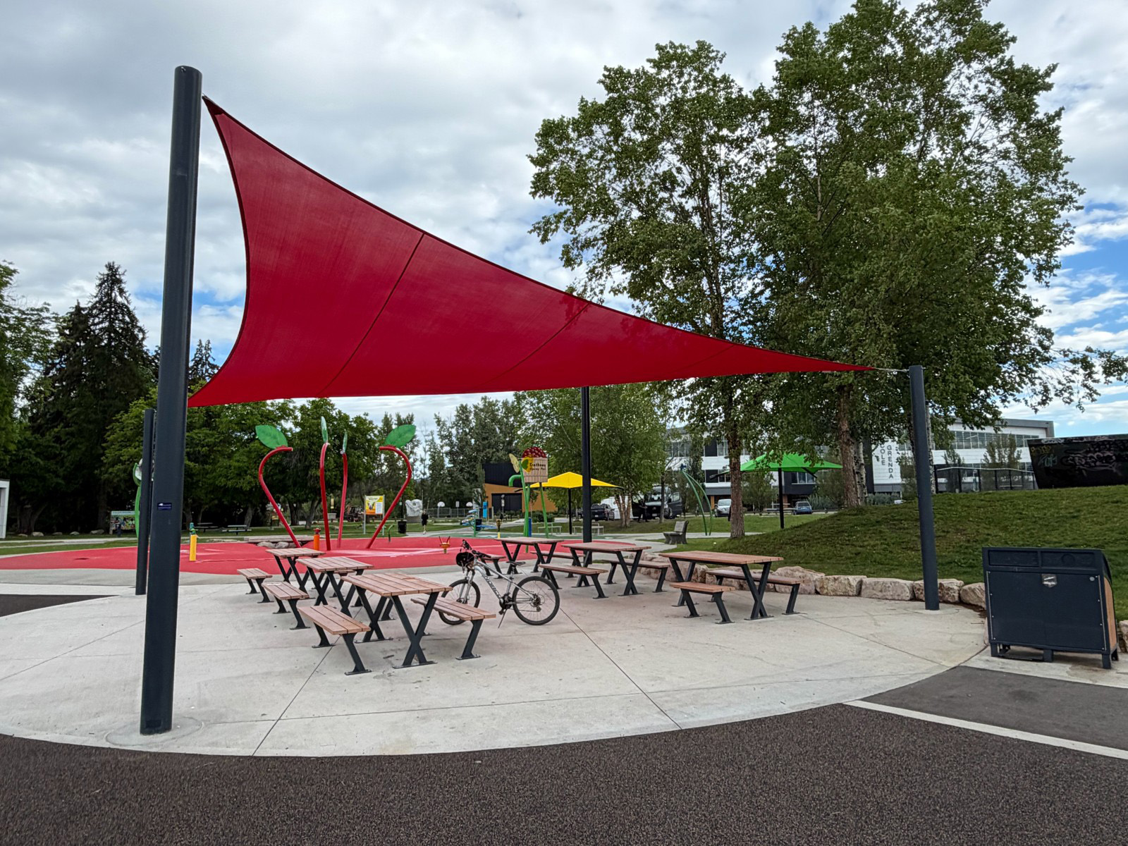 Shaded seating area with shade sails at Swalwell Park in Lake Country, BC.
