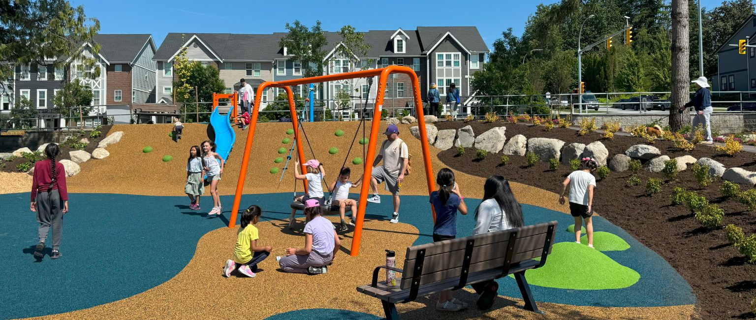 Busy community playground full of families in a neighbourhood in British Columbia.